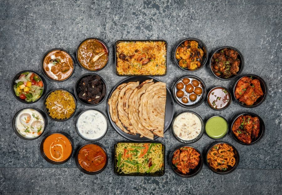 A sleek and professional corporate event setup at The Gandhi Indian Restaurant with a beautifully arranged table and elegant Indian dishes, representing a high-quality option for Gravesend Christmas party bookings.
